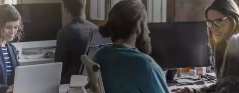 Colleagues discussing cybersecurity in an open office plan