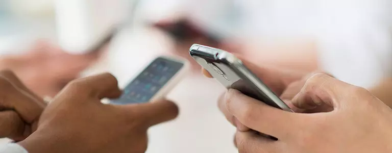 Closeup of people texting on their smartphones