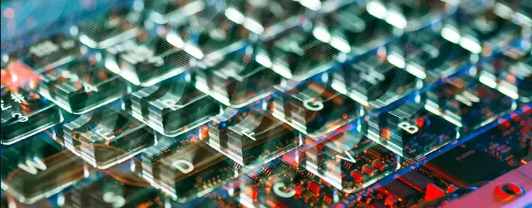 Closeup of laptop keyboard overlaid on electronics