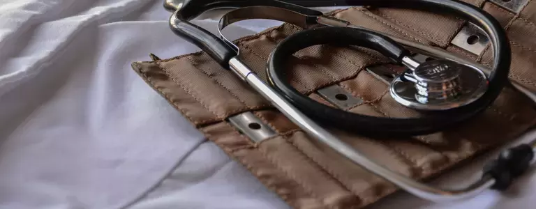 Stethoscope closeup with other medical devices on a lab coat