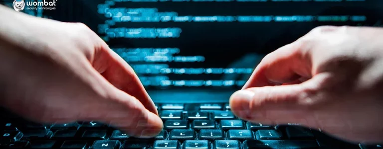 Closeup of hands coding on a computer keyboard