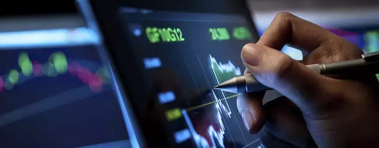 Closeup of someone using a pen on a tablet line chart
