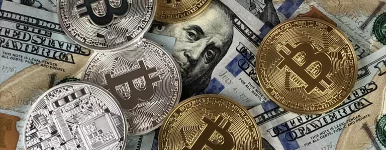Closeup of Bitcoins and 100$ bills
