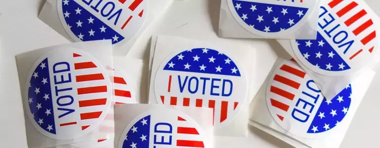 Unpeeled American ‘I VOTED’ stickers on a desk