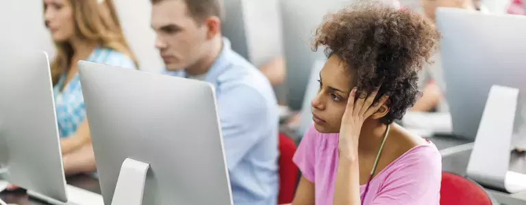 Employee looking bored looking at her computer at work