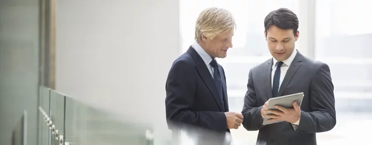 Cybersecurity experts discussing something on a tablet