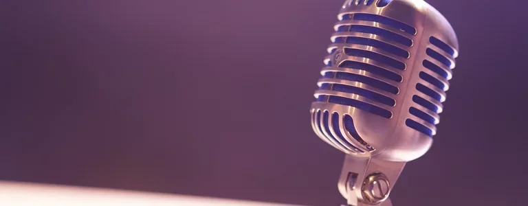 Closeup of an old school microphone on a stage