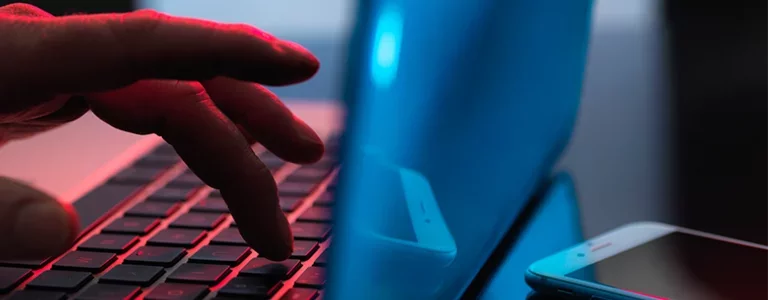Closeup of someone typing on a laptop