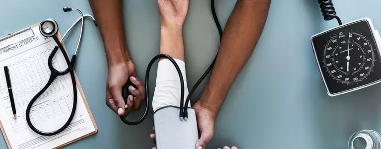 Doctor using a blood pressure cuff to check blood pressure