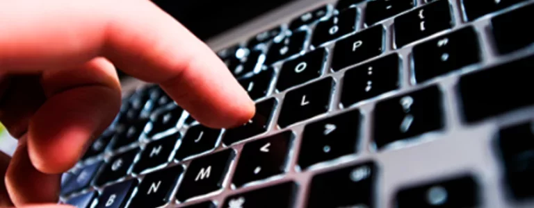 Zoomed in on a finger typing on a macbook