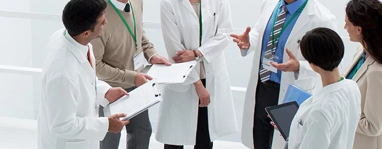 Medical professionals discussing healthcare email fraud attempts
