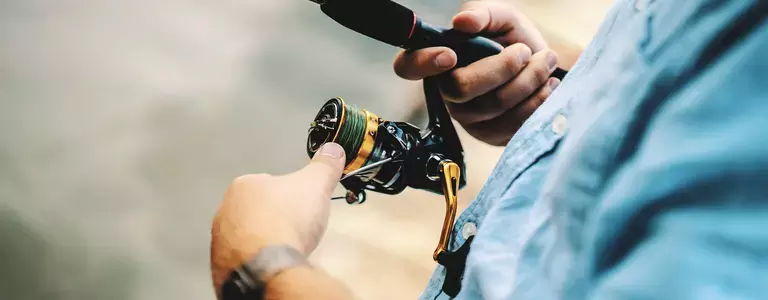 Closeup of a fishing reel being reeled