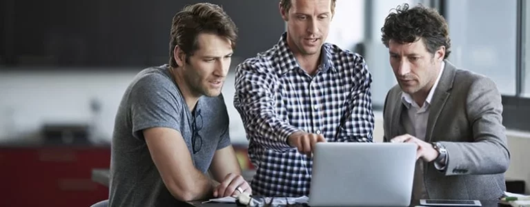 Businessman pointing at a laptop screen and talking