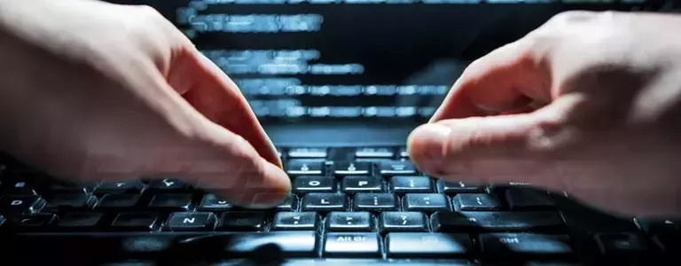 Closeup of person typing on a laptop