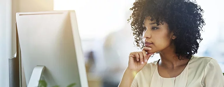 Cybersecurity worker looking at her computer screen